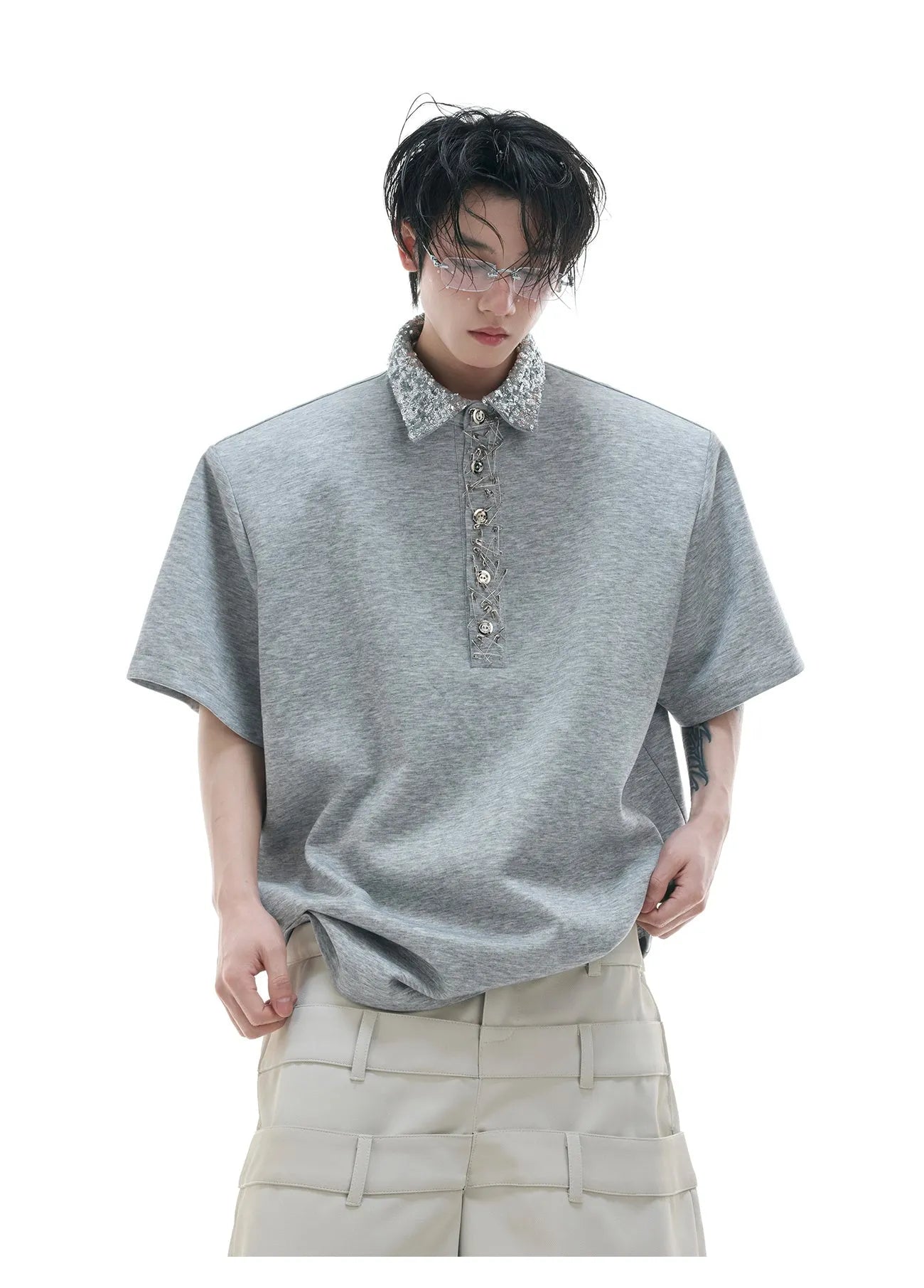 Loose fit black sequined shirt with square neckline and short sleeves on a model