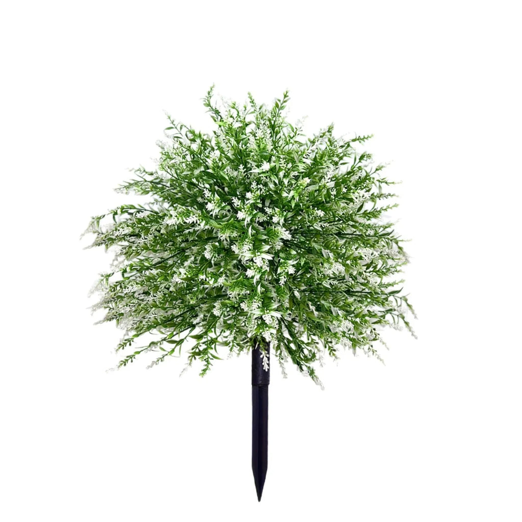 White plastic artificial lavender stem on a table, used as a decorative accent