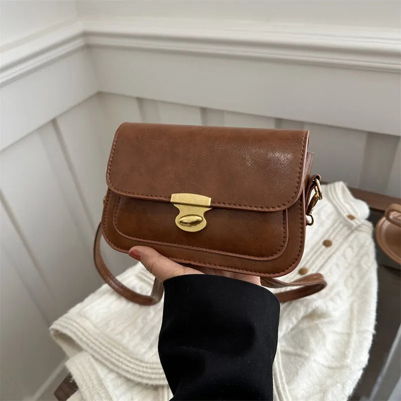 Small horizontal square handbag in soft PU leather, shown in black, brown, dark brown, and light brown.