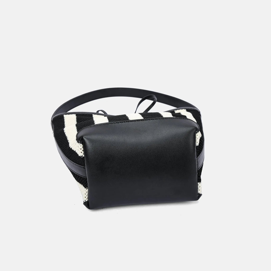 Black and white striped woven shoulder bag with bucket shape showing dimensions