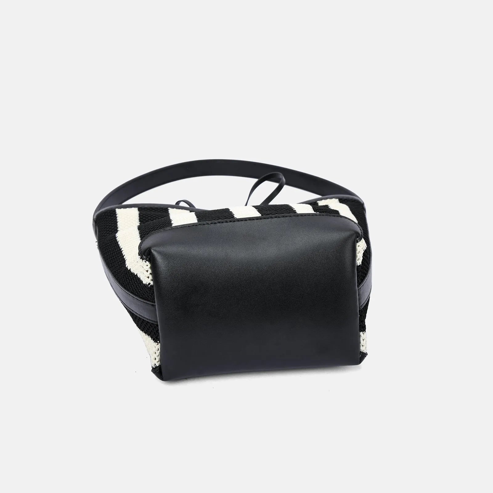 Black and white striped woven shoulder bag with bucket shape showing dimensions