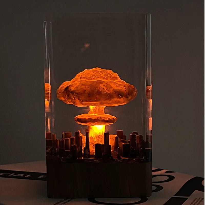 Small resin atomic bomb mushroom cloud night lamp ornament on a desk.