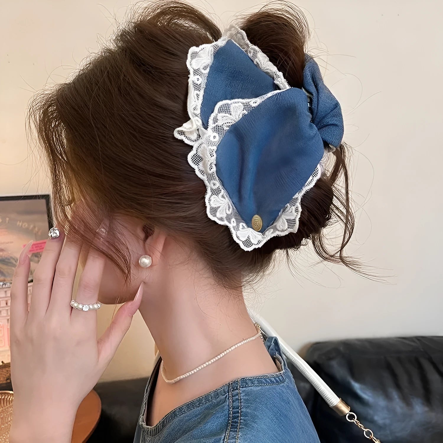 Handmade denim fabric and acrylic hair bow with triangle grip detail on plastic hairpin.