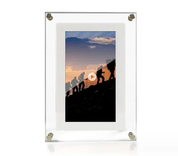 White vertical digital picture frame with acrylic casing on a table, showing a family photo on screen.