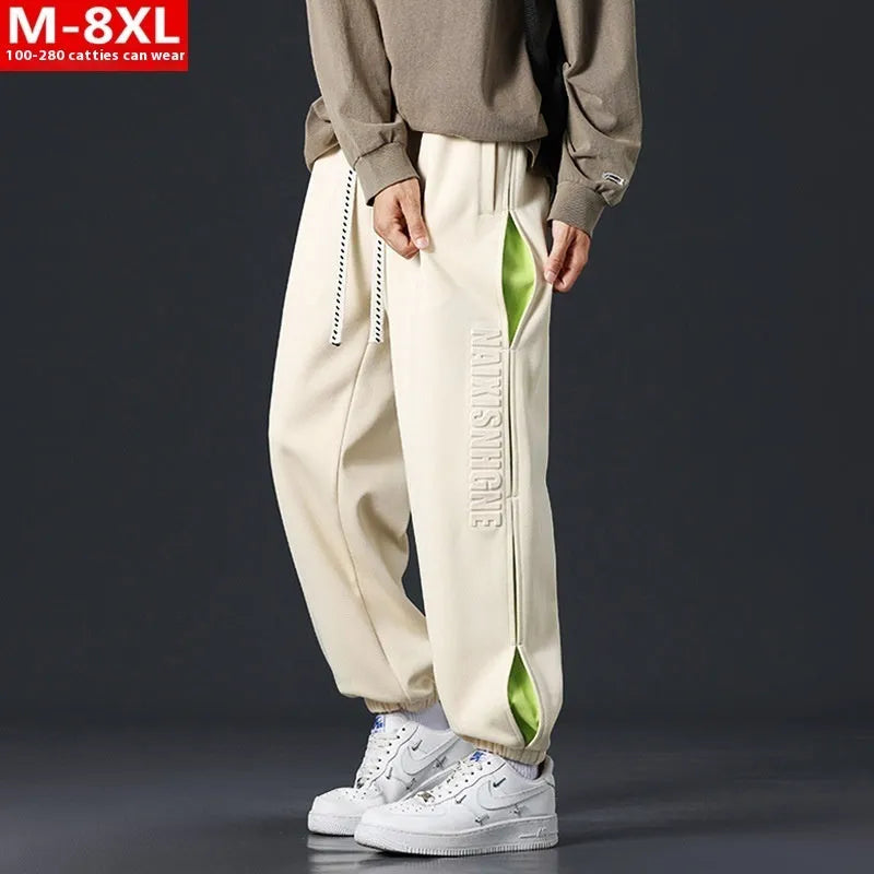Men's loose fit cotton pants with elasticated ankle bands in grey green colour, showing collage stitching detail.