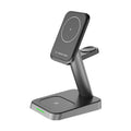 Black cube-shaped three-in-one wireless charging station for mobile phone, watch, and earbuds.