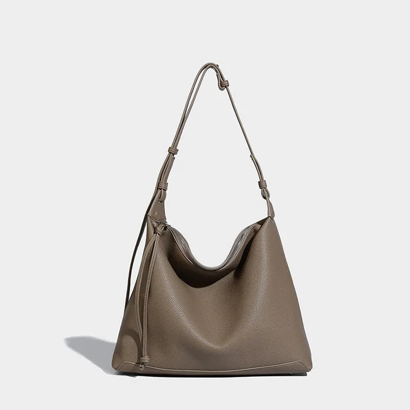 Soft PU leather messenger bag in caramel colour showing large capacity and shoulder strap.
