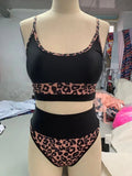 White and leopard print women's high waist split leg bikini swimsuit briefs on a mannequin.