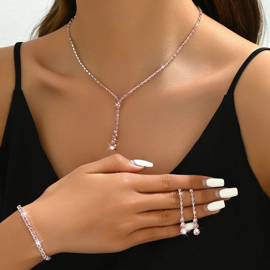 Wedding jewellery three-piece set showing necklace, bracelet and earrings with rhinestone pendants