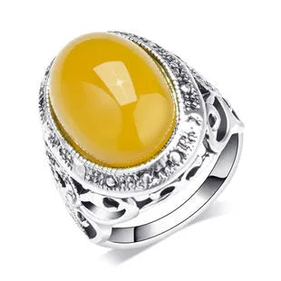 Geometric retro alloy ring in antique silver amber colour on a grey background.