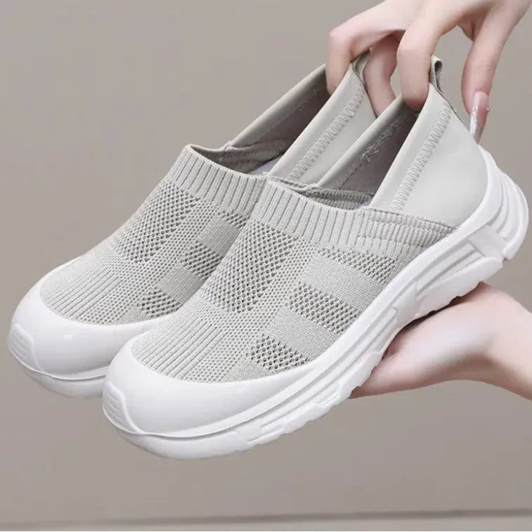 Women's black slip-on shoes with cloth upper and PVC sole showing one pedal design
