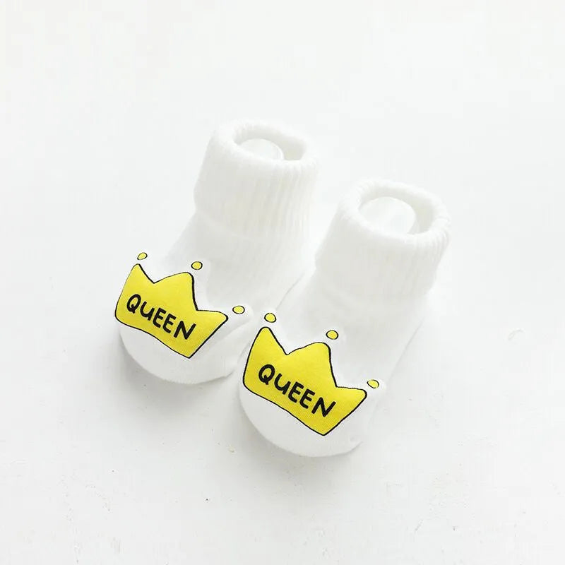 Baby socks with non-slip rubber grip soles on the feet, shown in a light grey colour.