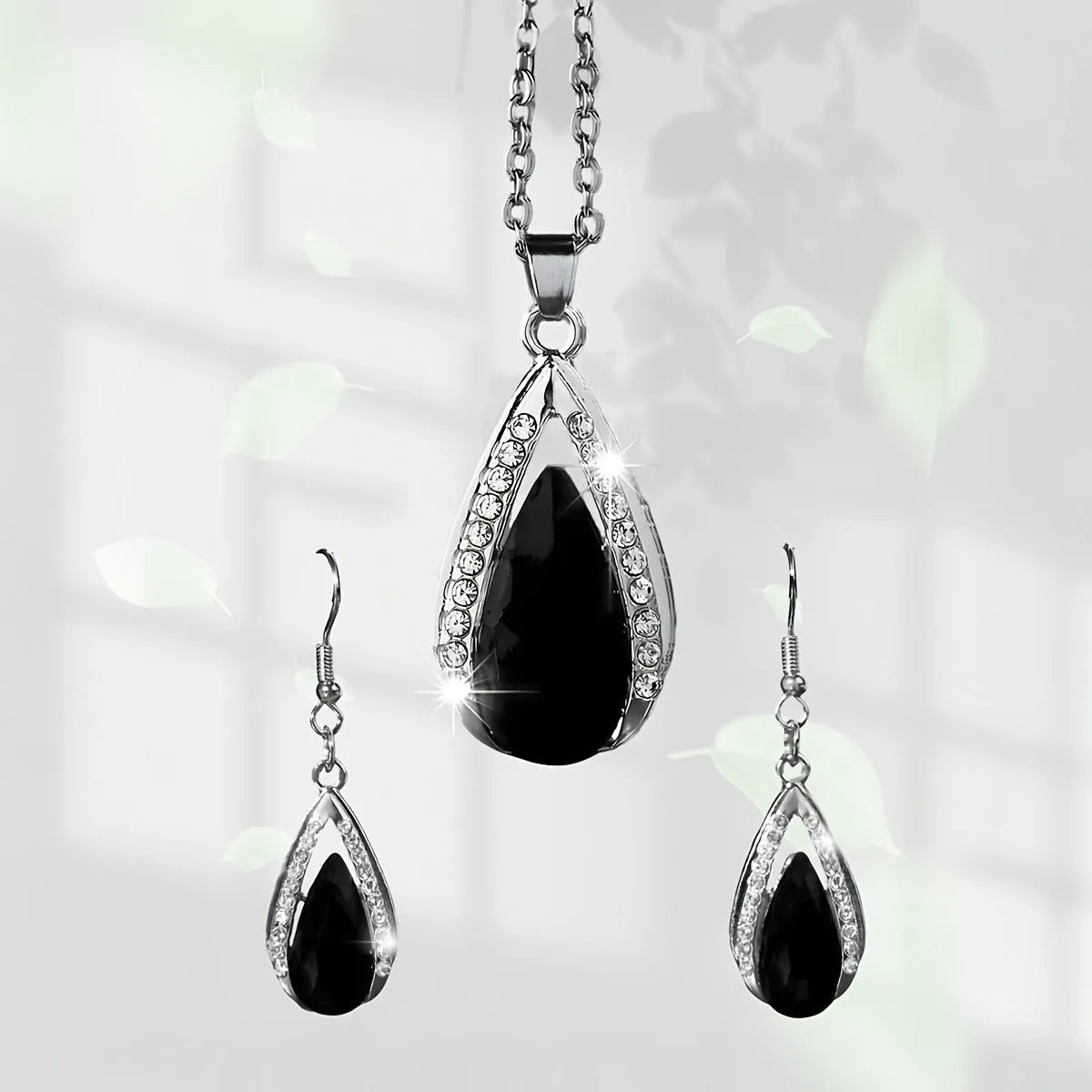 Black and red teardrop pendant alloy necklace and matching earrings set on a white background.