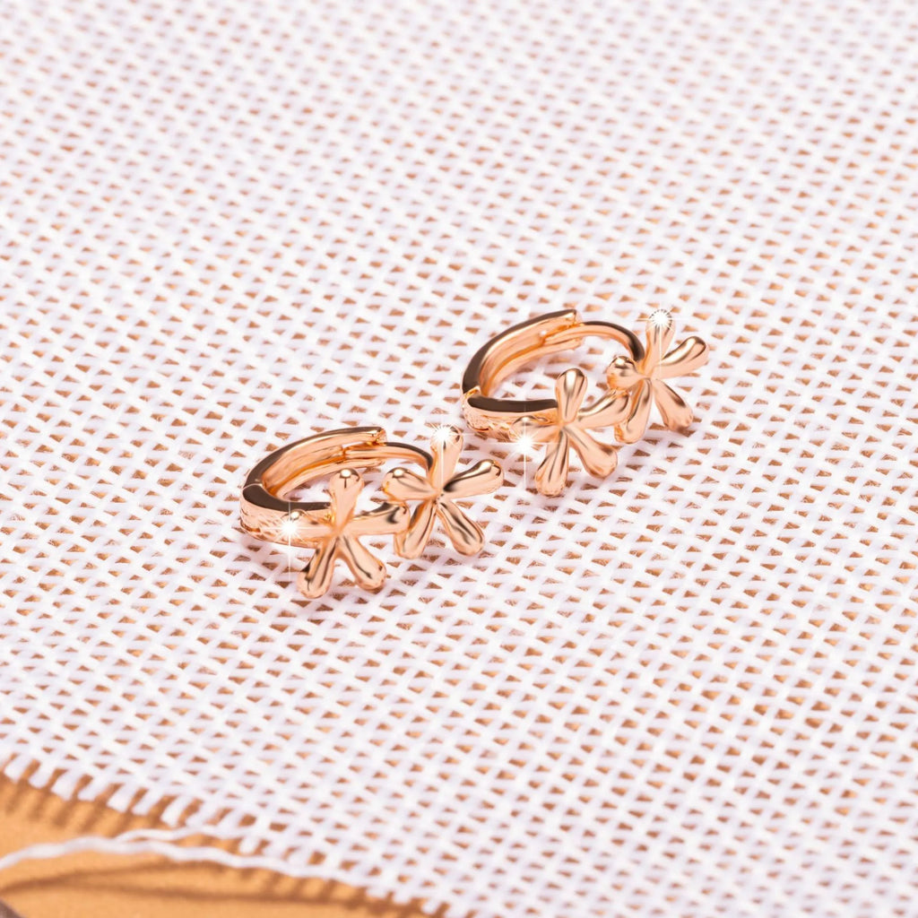 A pair of rose gold circular earrings featuring a waterdrop floral design with a fresh, sweet style.