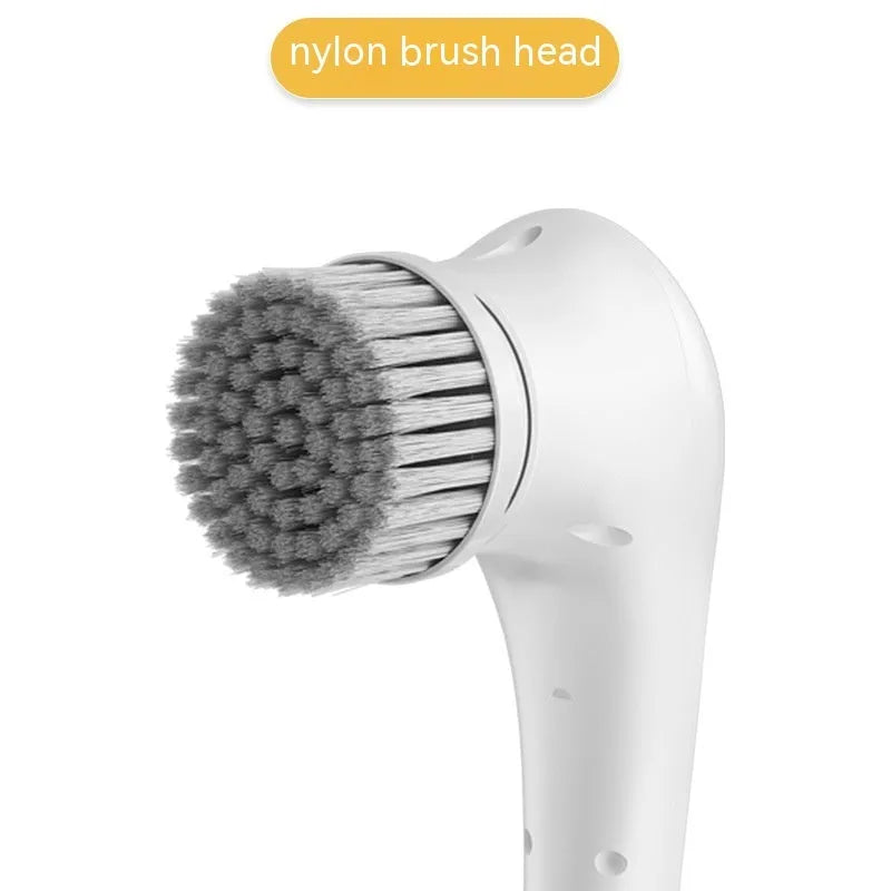 White USB electric handheld cleaning brush with five different brush heads for kitchen and bathroom surfaces.