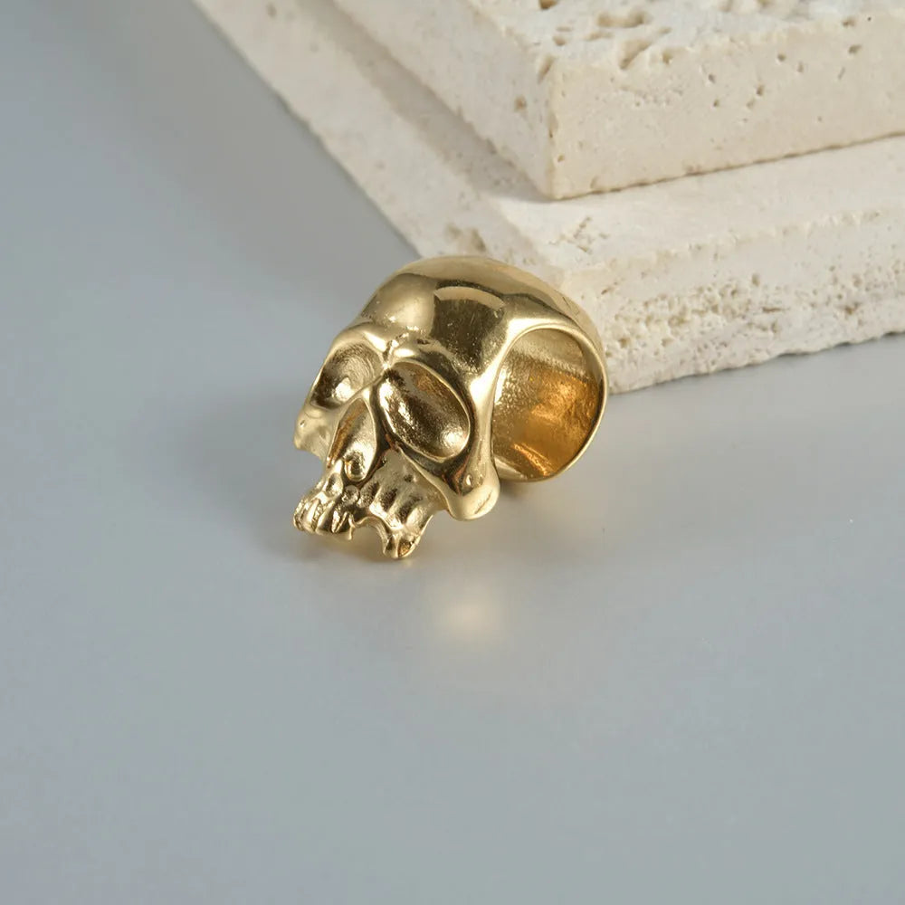 Stainless steel hollow skull Buddha earring in a geometry shape, shown in one of four colour options.