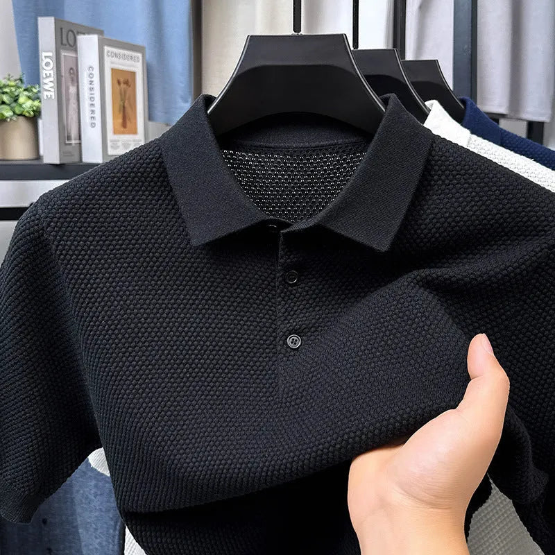 Man wearing a loose grey cotton short sleeve pullover sweater in a casual setting
