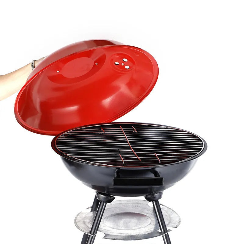 A portable cast iron barbecue oven with a 14-inch cooking surface, shown outdoors.
