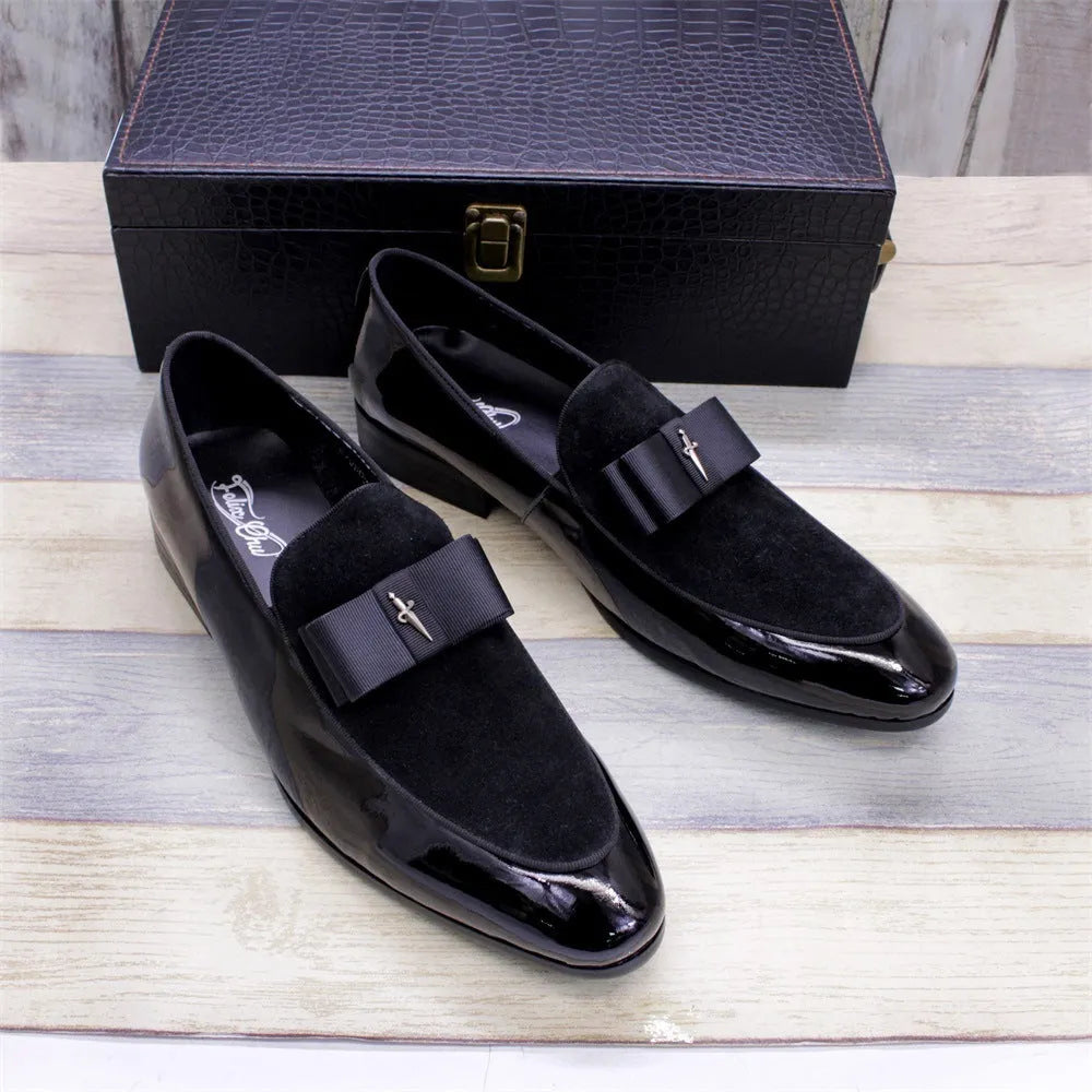 Men's glossy black patent leather low-top shoes with a tassel detail on a white background.
