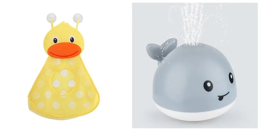 White and blue whale-shaped bath toy spraying water with LED lights on, floating in a baby bath