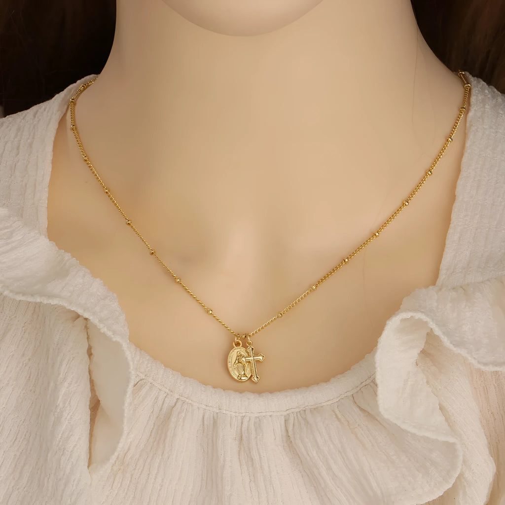 Geometric Virgin Mary cross pendant necklace in gold colour on a chain