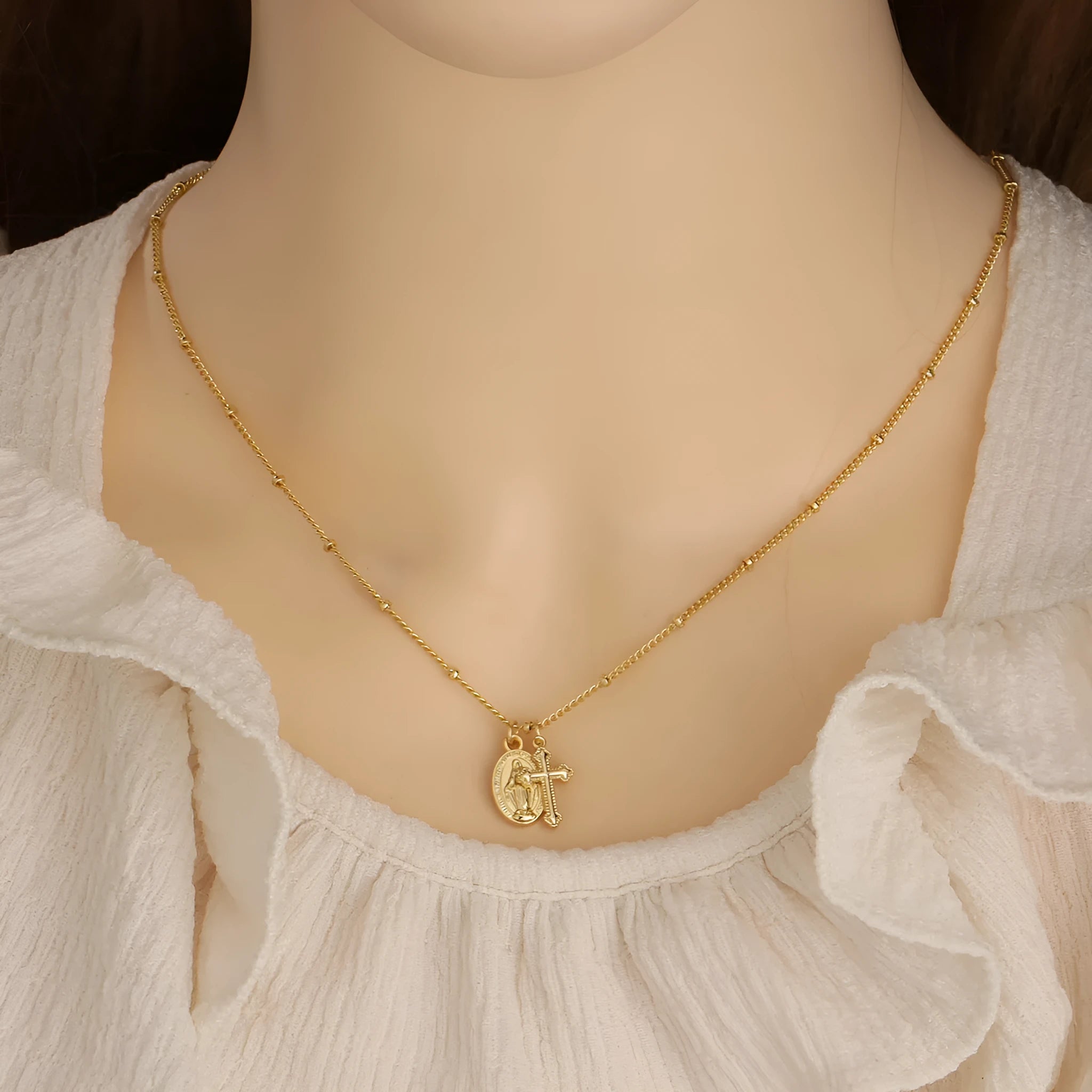 Geometric Virgin Mary cross pendant necklace in gold colour on a chain