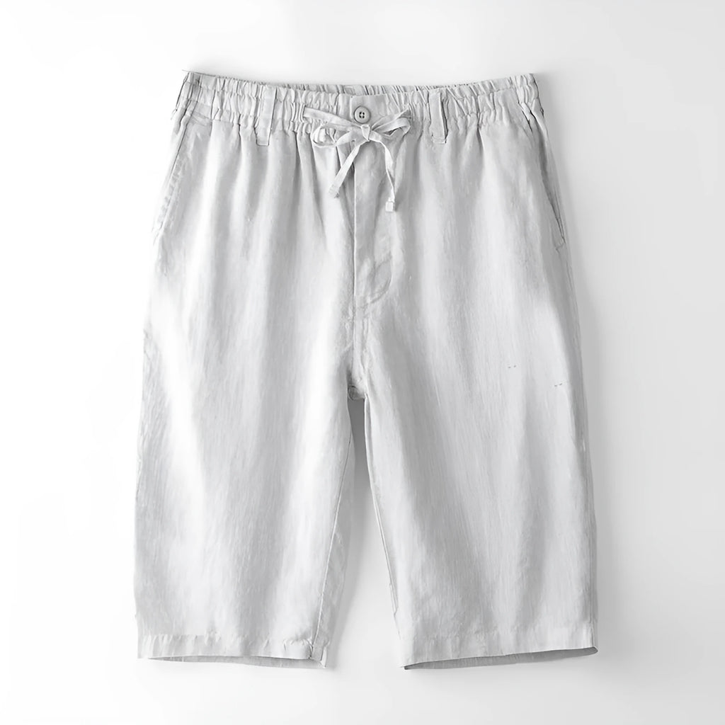 Men's loose-fitting linen capri trousers in a straight-leg style on a neutral background.