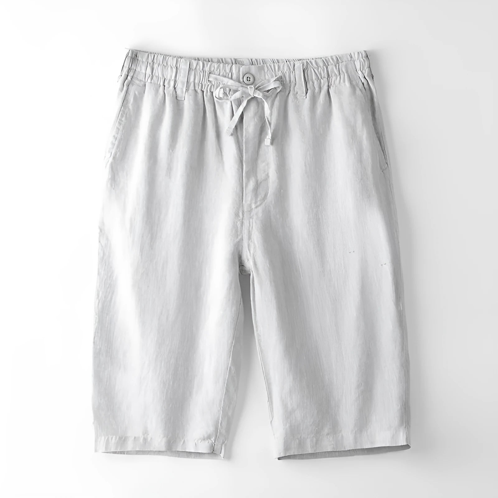 Men's loose-fitting linen capri trousers in a straight-leg style on a neutral background.