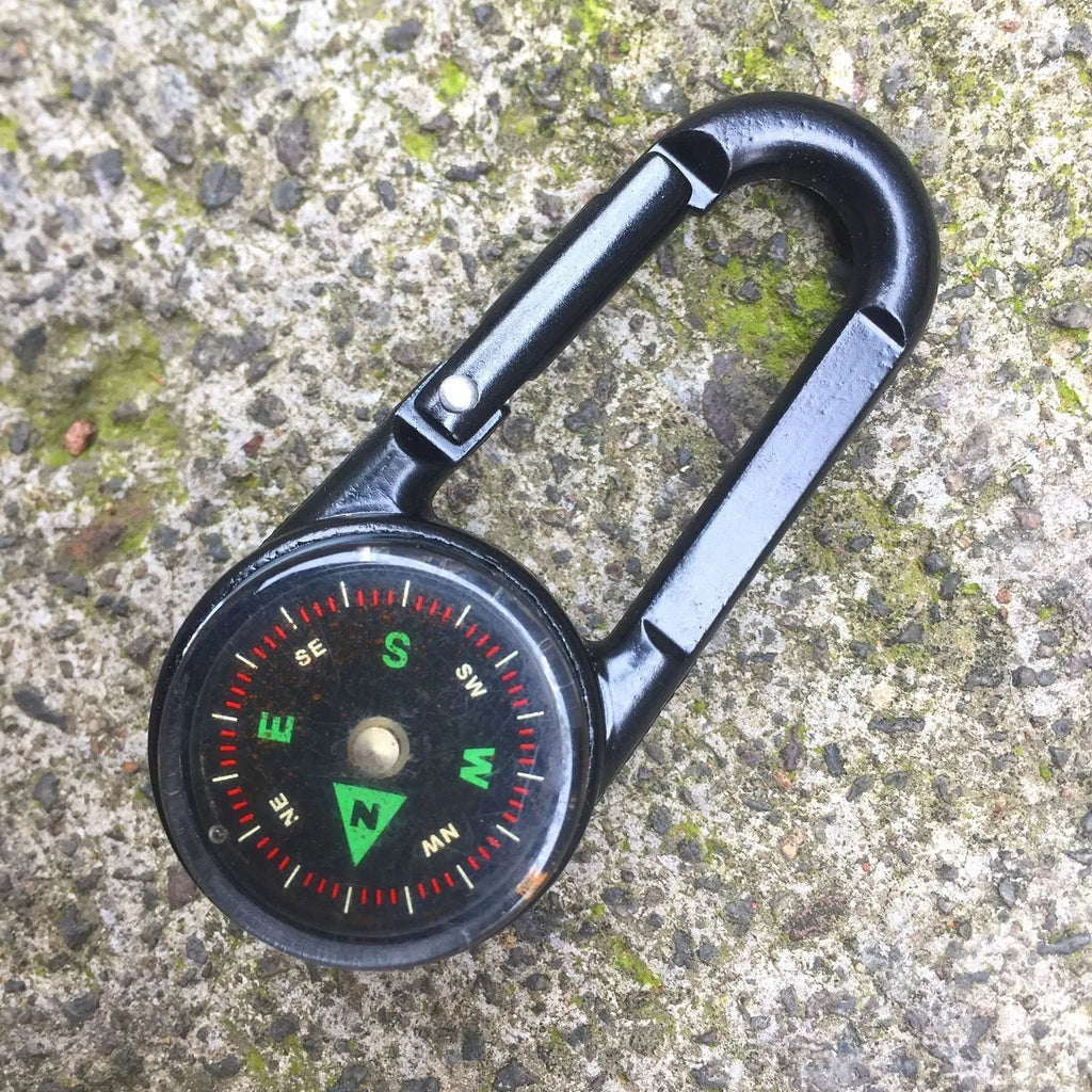Army green zinc alloy outdoor carabiner with built-in fluid compass and liquid thermometer showing temperature scale