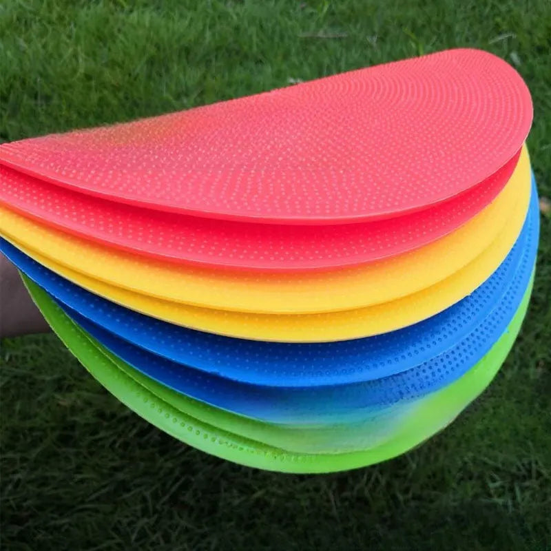 23cm diameter football training landmark pad in bright colours on grass field