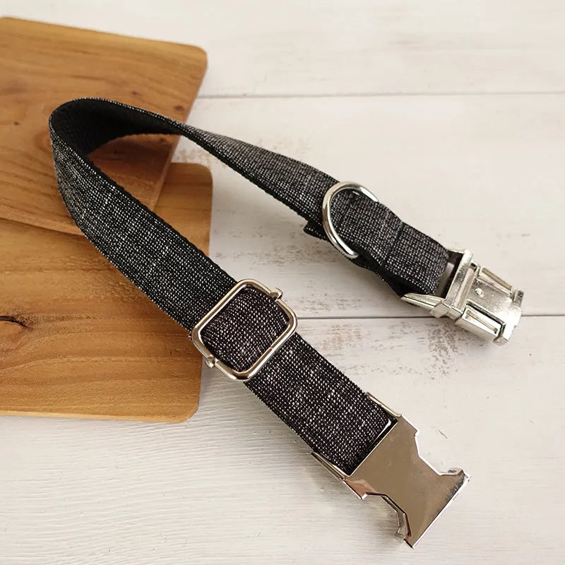 Black polyester padded dog collar with light gold trim and matching lead on a light surface