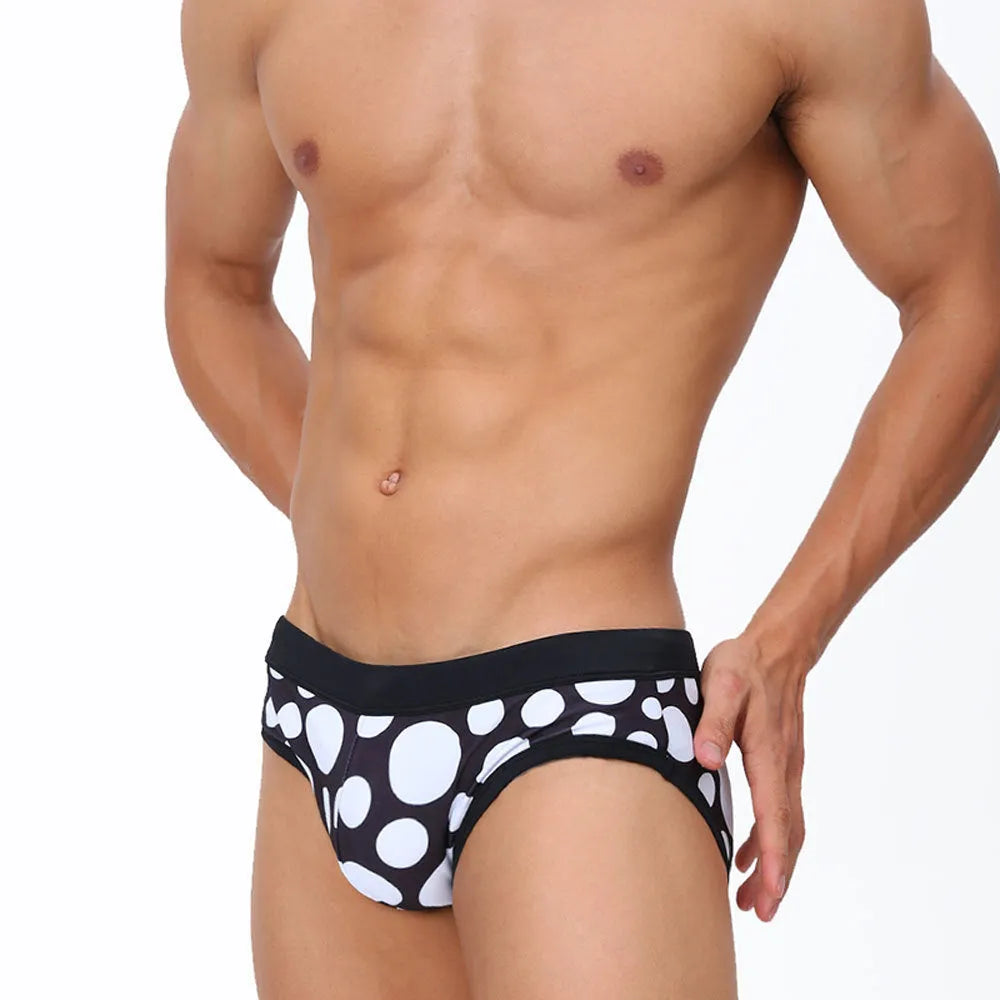 Men's triangle printed swimming trunks with cups, black ribbon cup design, polyester fabric, front view