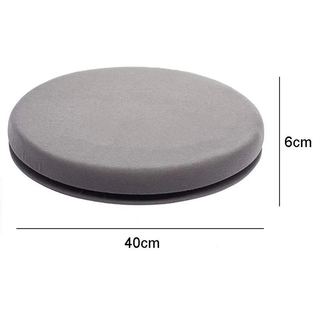 A grey rotating car seat cushion with a short plush cover, shown on a car seat.