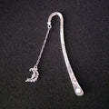 Metal bookmark with glowing five-pointed star and celestial sun moon stars design