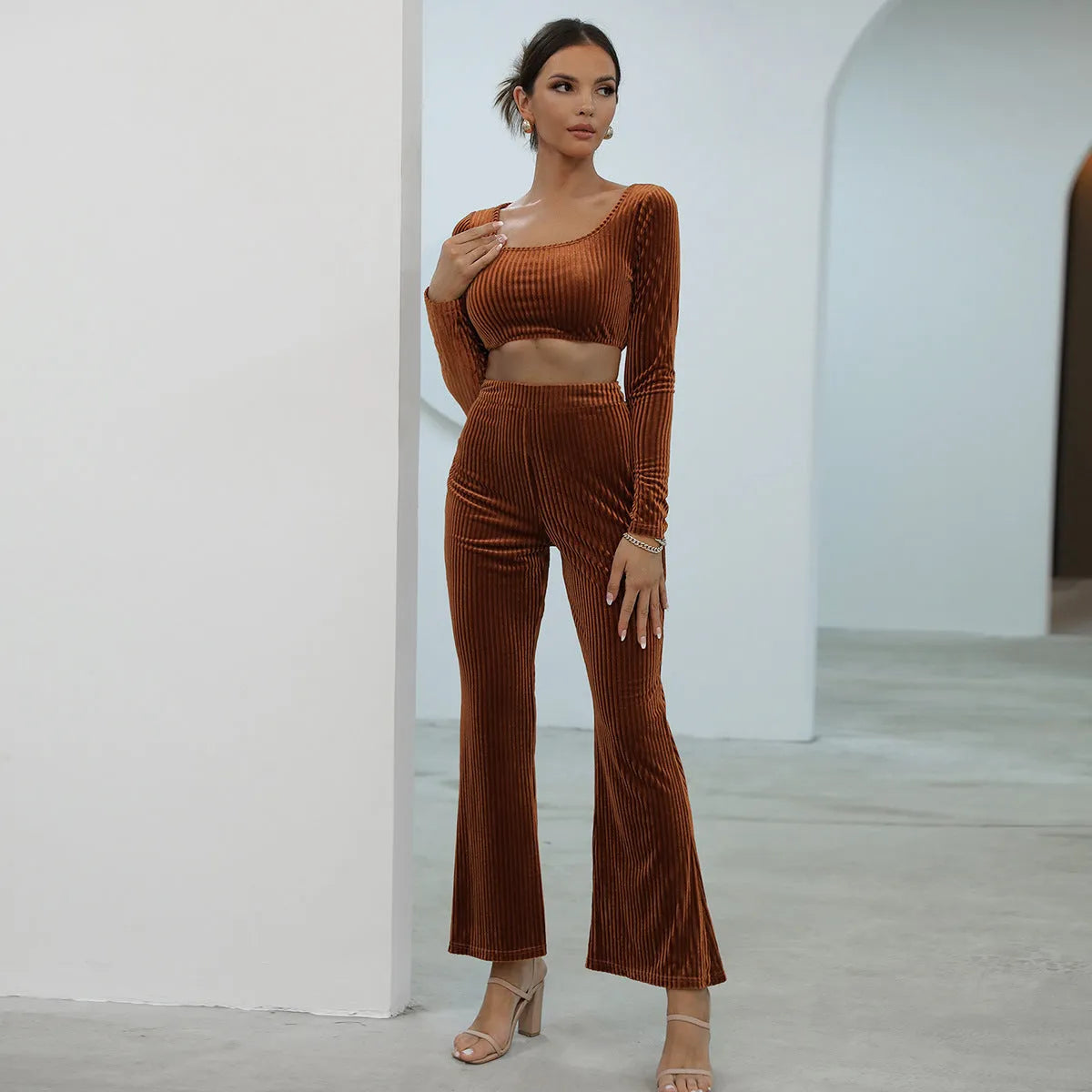 Women's caramel coloured sweater set with long sleeves and matching trousers on hanger