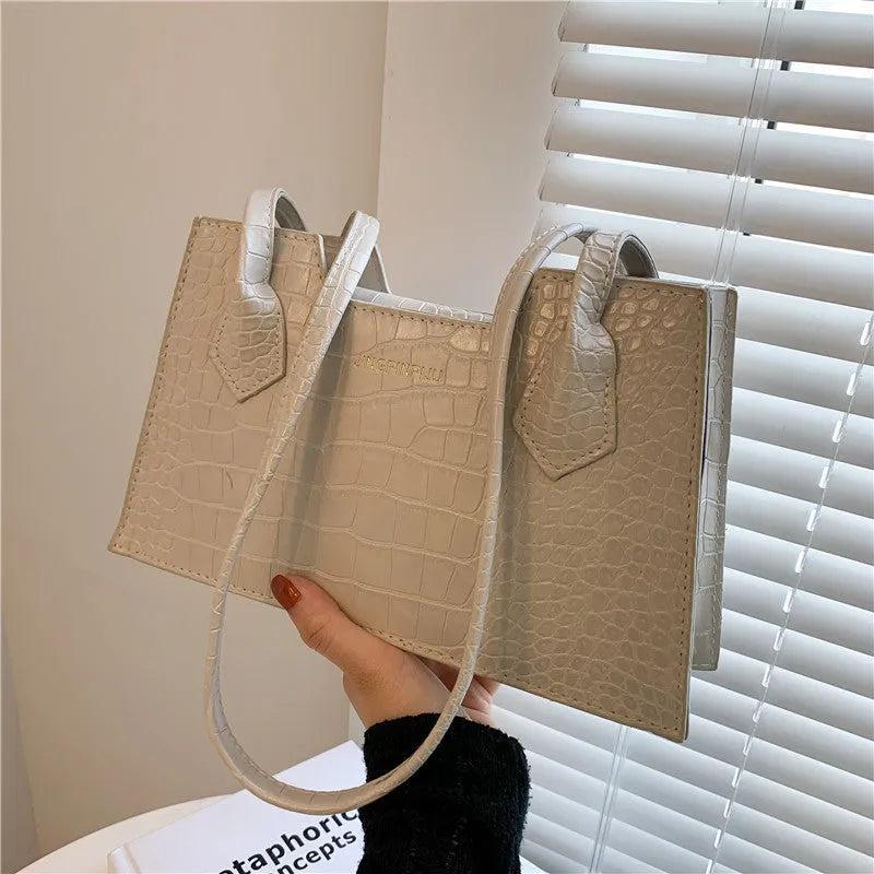 Small square PU handbag with crocodile pattern, sewing line detail, medium hard build, 27x16x7cm, black colour