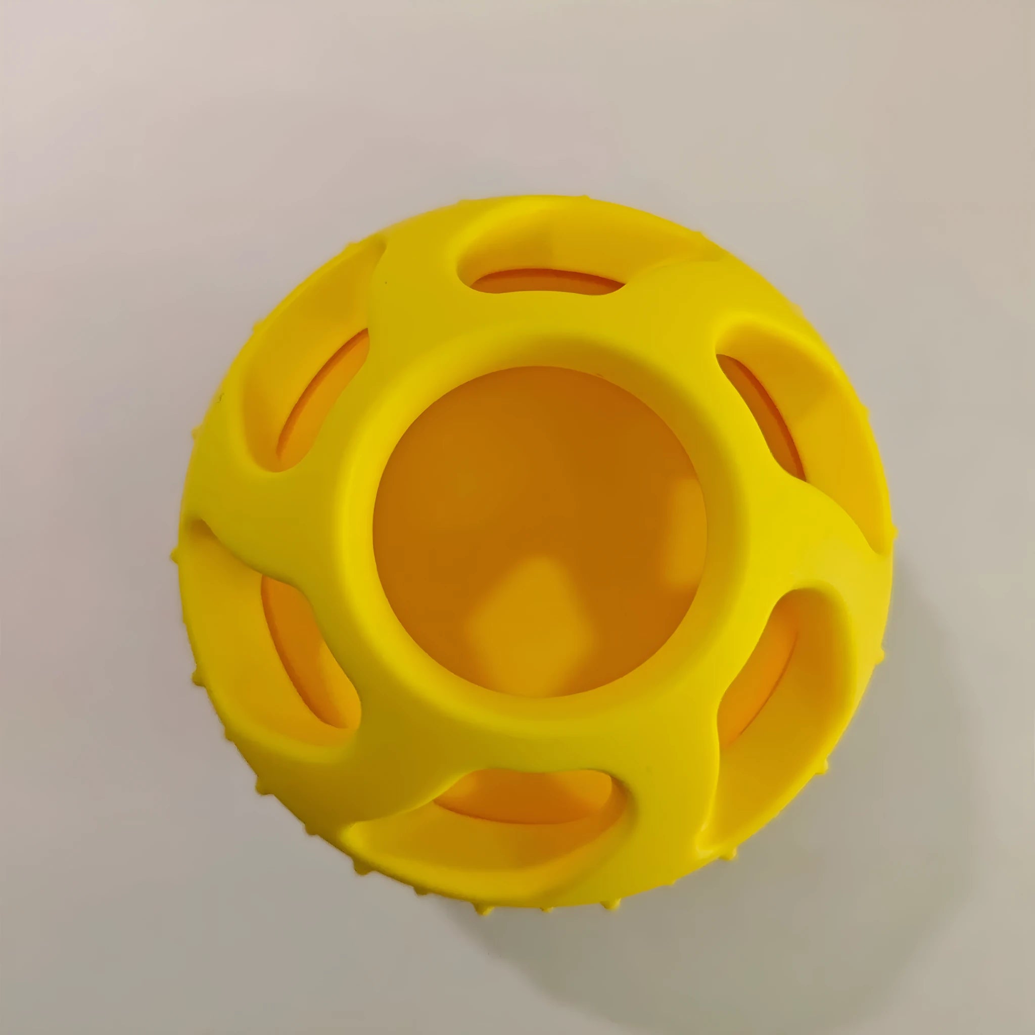Yellow silicone pet slow feeder ball with snack mould for dogs and cats