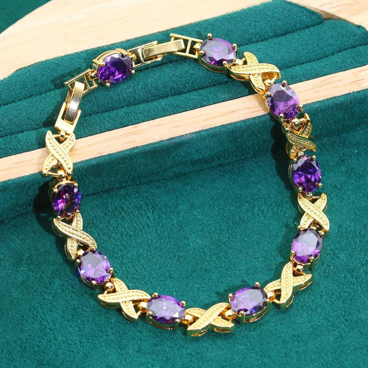 18k gold plated jewellery set showing ring, earrings, bracelet, and necklace with coloured cubic zirconia stones