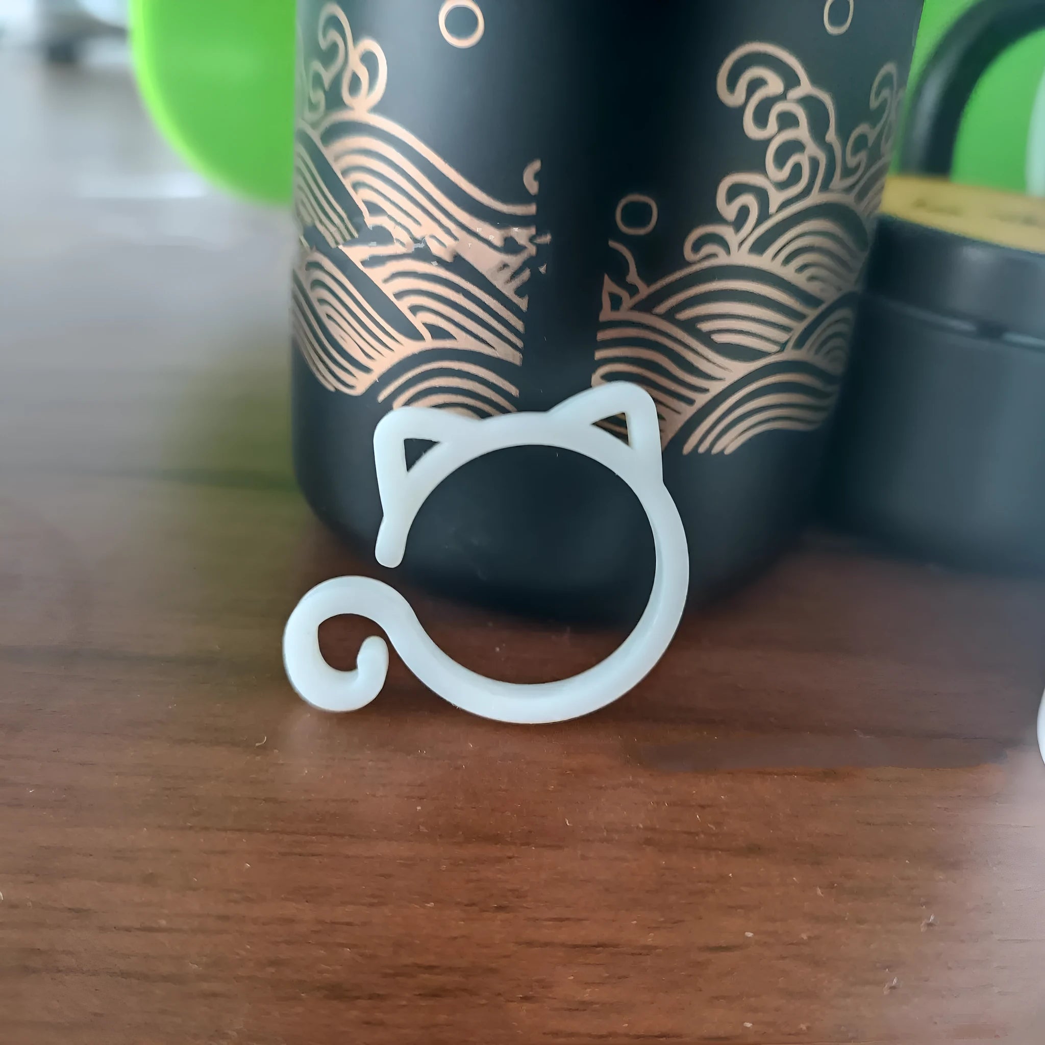 Cat-shaped plastic plant clip in gardening setting with colour options