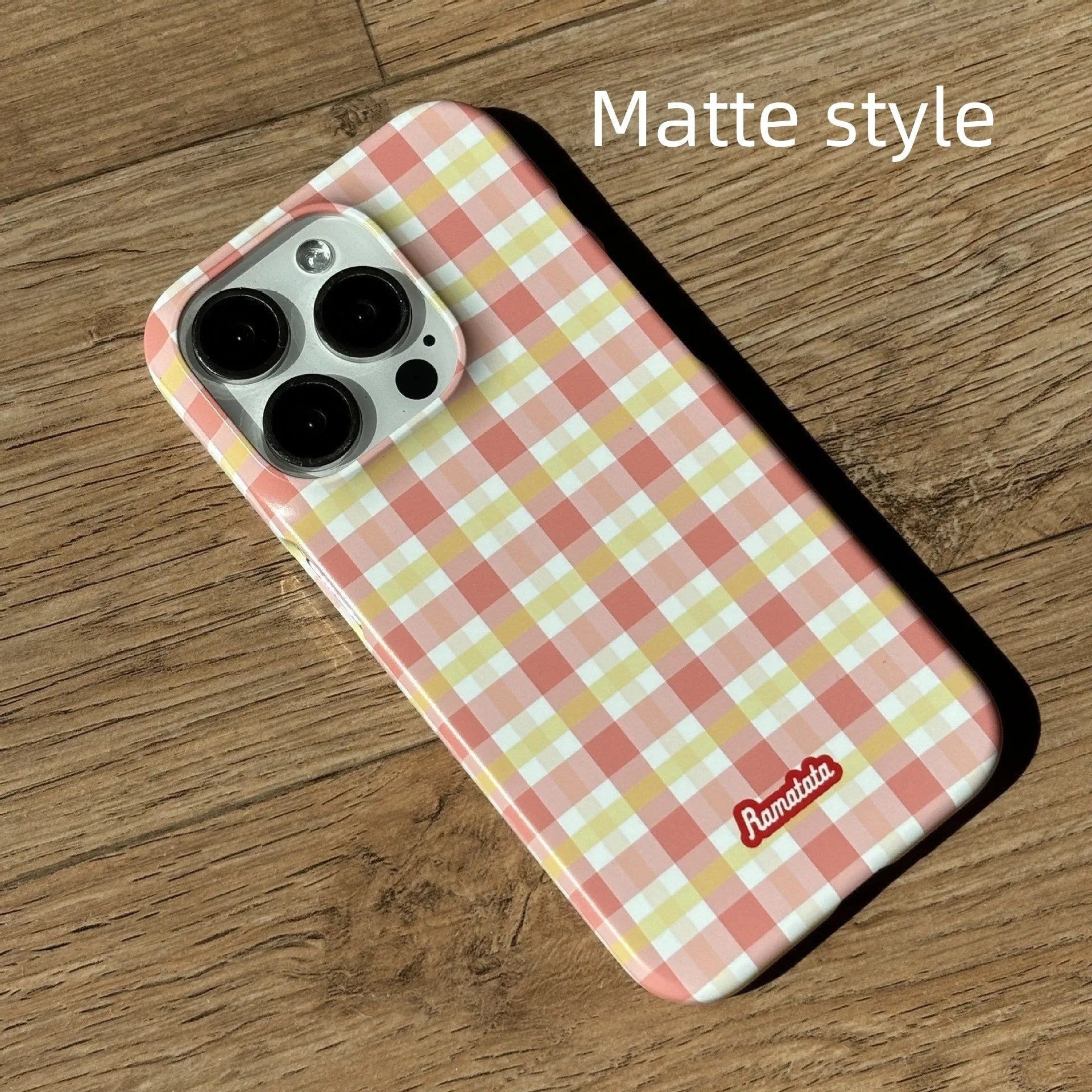 iPhone 15 Pro Max phone case with red and orange plaid design on glossy and frosted feilin shells.