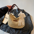 Women's woven straw messenger bag with hollowed design and single shoulder strap in khaki colour