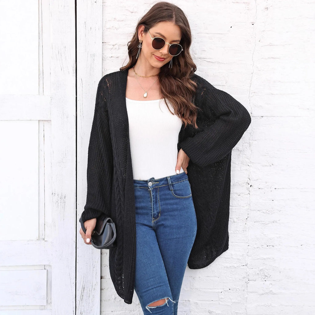 Women's loose fit acrylic sweater coat in a solid colour, shown on a hanger.