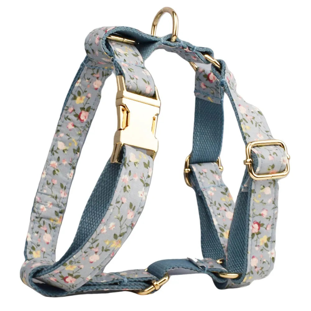 Blue floral patterned dog collar set with matching leash, bow, vest, and poop bag accessories