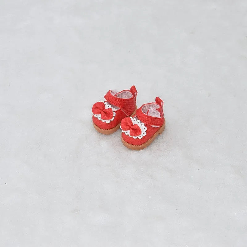 A pair of 17cm scale PU doll shoes in a selected colour and style, such as black leather shoes or brown boots.