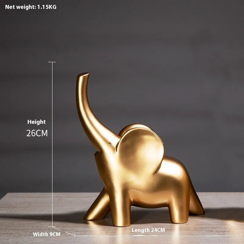 Modern resin elephant ornament in rose gold colour with raised trunk on display surface