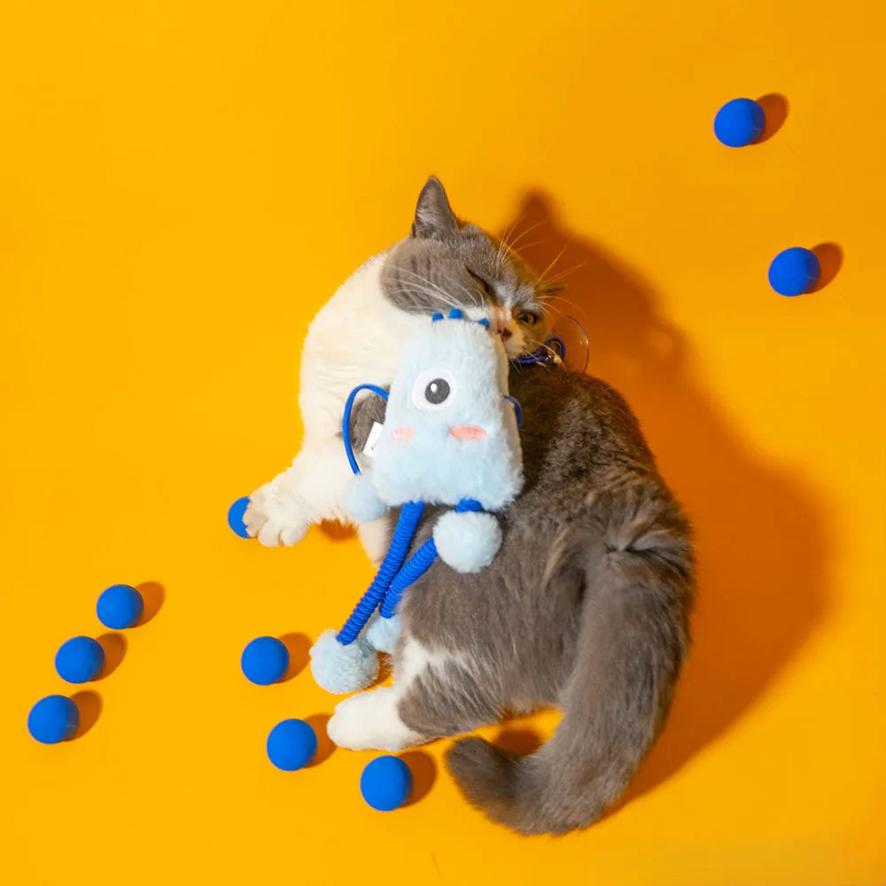Blue plush elastic cat toy with bell in a ring shape on a light background