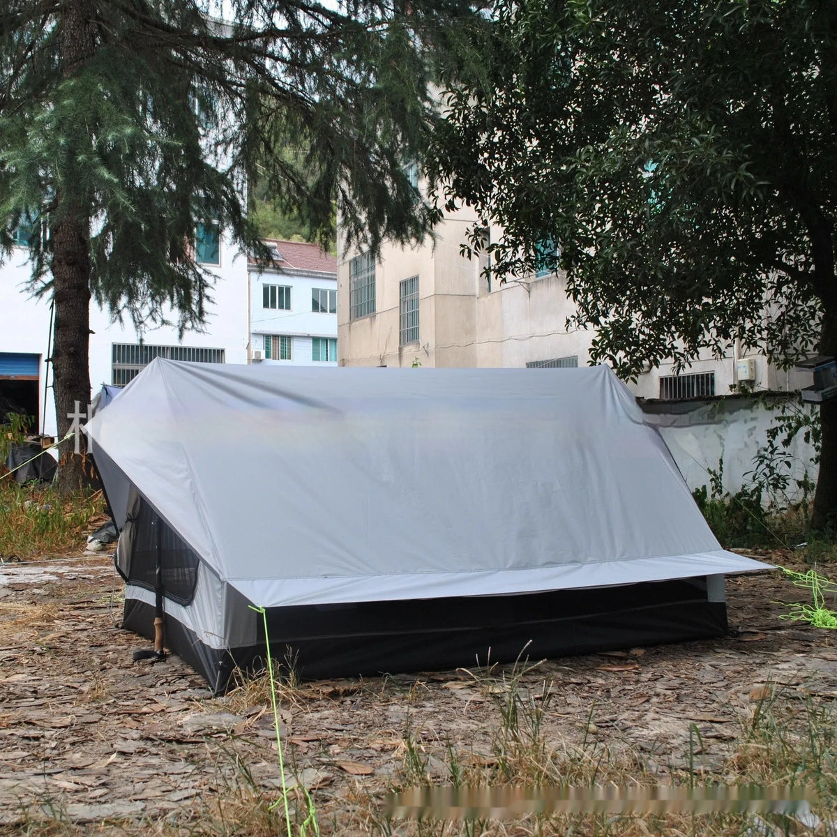 Brown A-line tent for 2-3 people with PU4000 waterproof fabric, 210x150x110cm, set in a grassy campsite.