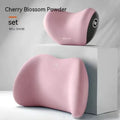 Black memory foam car lumbar support pillow and matching headrest pillow on a car seat.