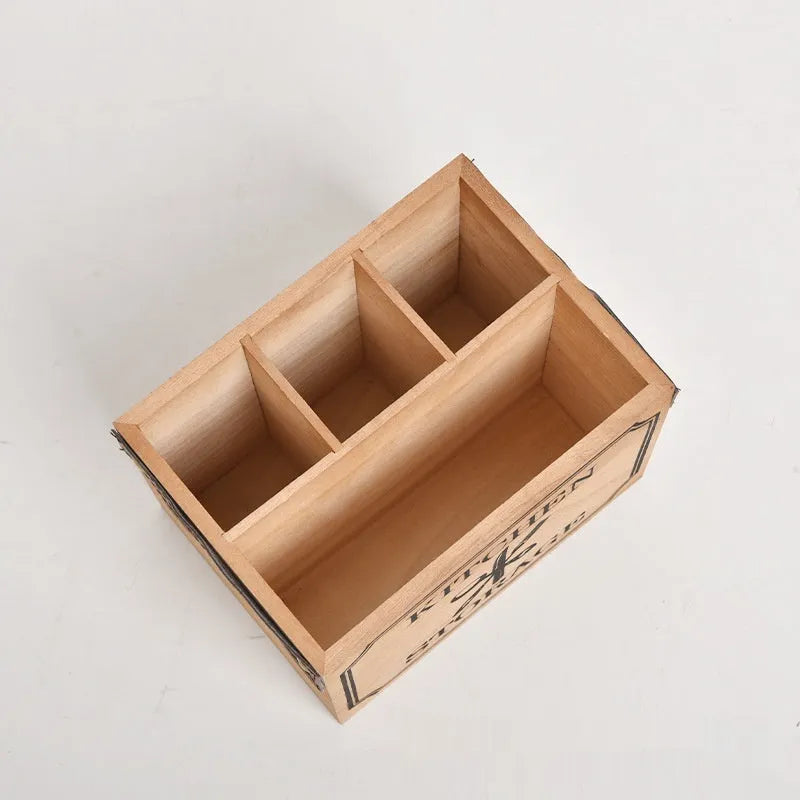 Open wooden kitchen storage box with grid divider for knives, forks, and chopsticks.
