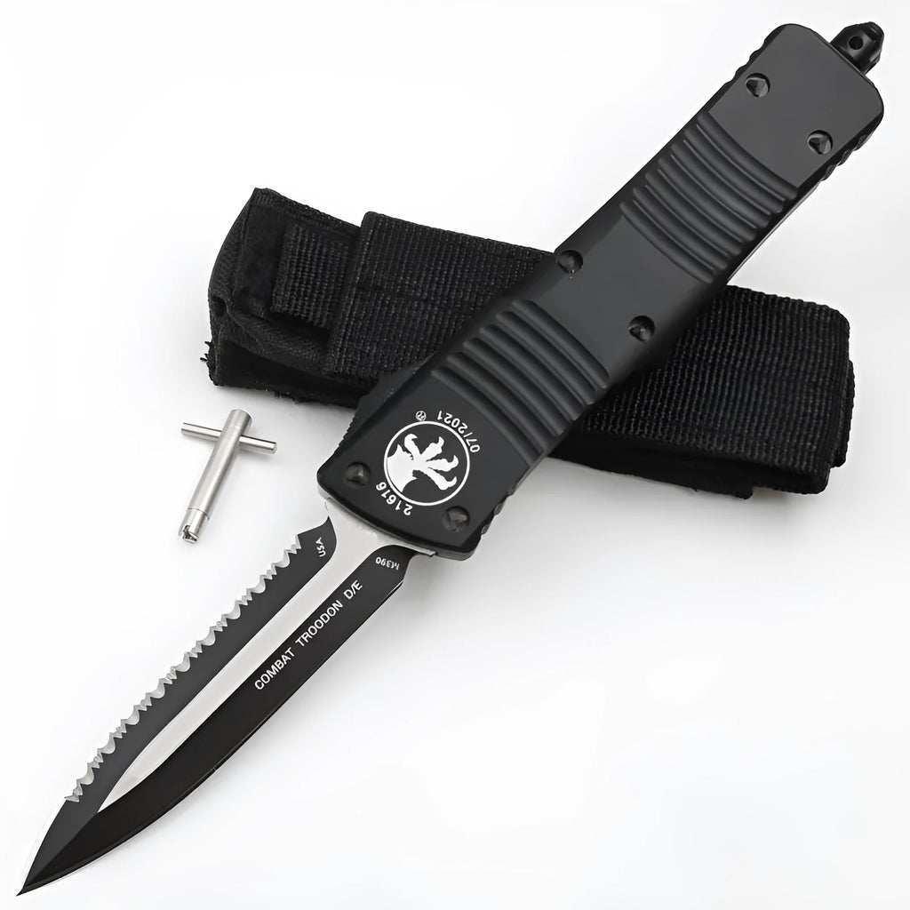 Black folding knife with D2 steel blade and aviation aluminium handle open on a dark surface